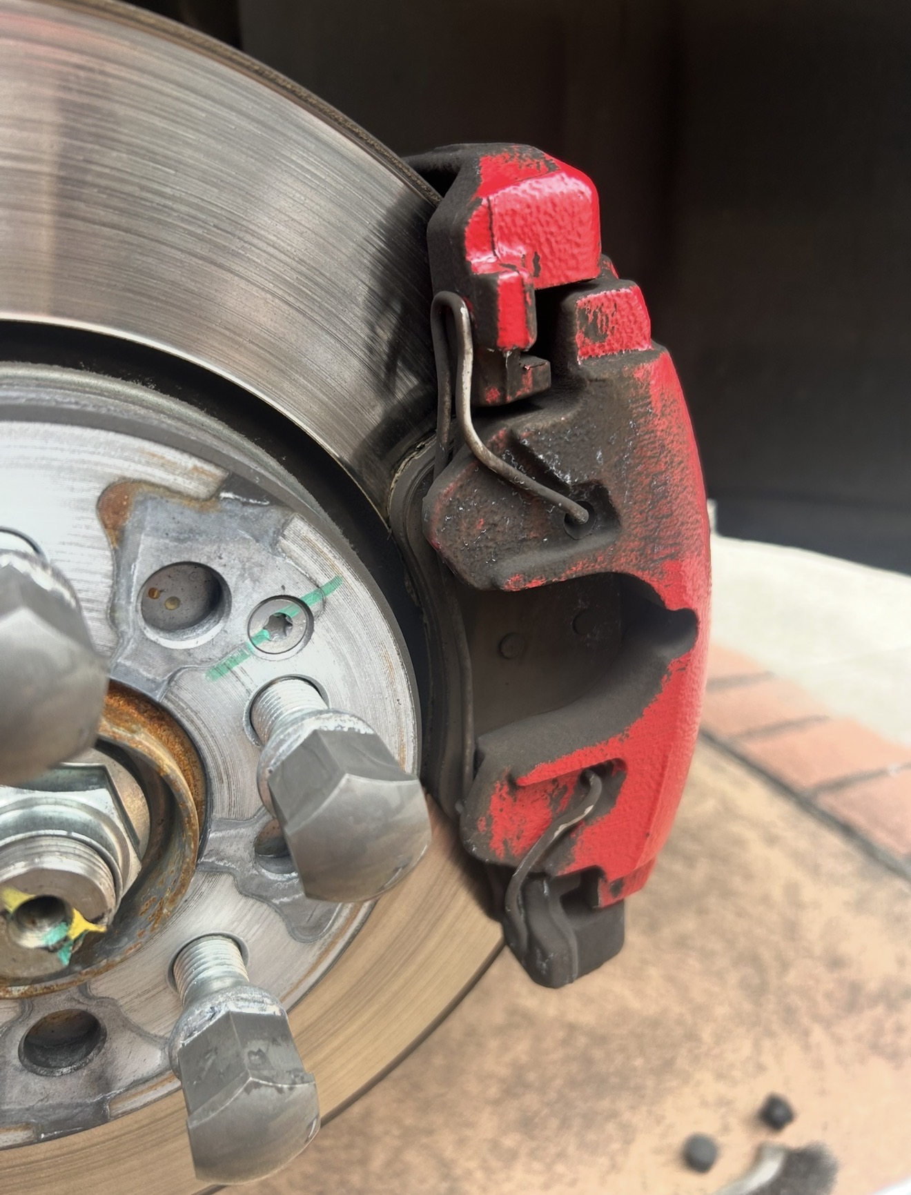 Close-up of a brake disc and red caliper on a vehicle